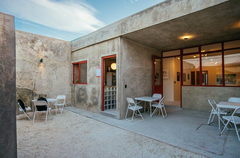 Outdoor patio with tables and chairs on a concrete surface
