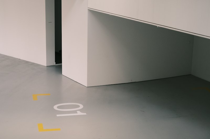 Coated parking floor with yellow and white safety markings