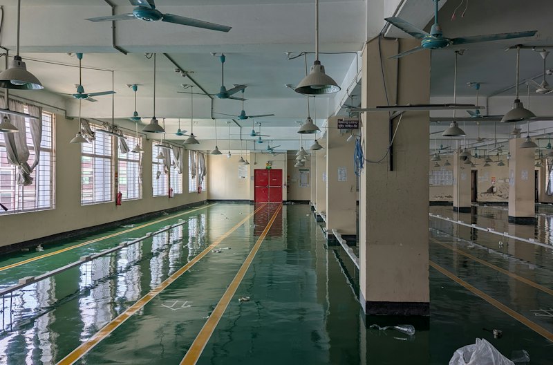 Long hall with a glossy green coated floor and yellow safety lines